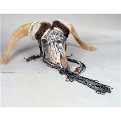 A HAND PAINTED AND SEMI-PRECIOUS STONE DECORATED DAHL SHEEP SKULL SCULPTURE