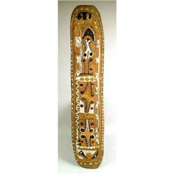 A CARVED AND POLYCHROME PAINTED WARRIOR SHIELD