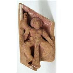 A CARVED FIGURAL SANDSTONE FRAGMENT