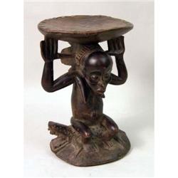 A CARVED AFRICAN AND METAL MOUNTED FIGURAL STOOL