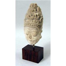 A CARVED STONE HEAD FRAGMENT