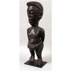 A CARVED AFRICAN FIGURE OF A WOMAN
