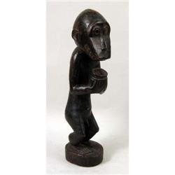 A CARVED AFRICAN FIGURE OF A MONKEY