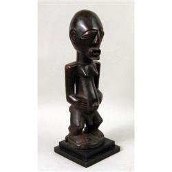 A CARVED AFRICAN FIGURE OF A MALE