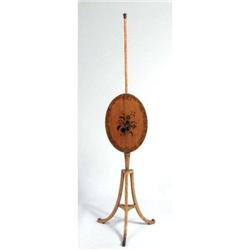 AN EDWARDIAN PENWORK-DECORATED SATINWOOD FIRE SCREEN