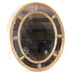 A REGENCY GILTWOOD OVAL LOOKING GLASS