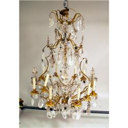 A LOUIS XV STYLE GILT BRONZE AND ROCK CRYSTAL MOUNTED TWELVE LIGHT CHANDELIER