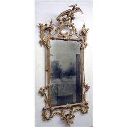 A ROCOCO CARVED PINE GILTWOOD LOOKING GLASS