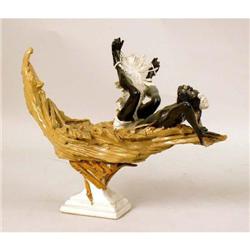 A SCULPTURE OF A MAN IN A BOAT