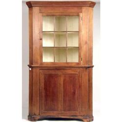 A CHIPPENDALE CHERRYWOOD GLAZED-DOOR TWO-PART CORNER CUPBOARD