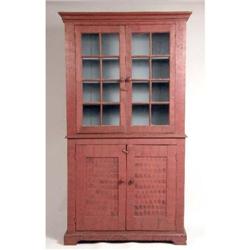A BLACK-AND-RED SPONGE- AND COMB-PAINTED GLAZED DOOR TWO-PIECE CUPBOARD