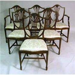 A SET OF EIGHT GEORGE III STYLE CARVED MAHOGANY SHIELD BACK DINING CHAIRS