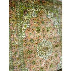 AN ORIENTAL SILK RUG