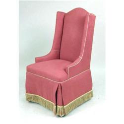 AN UPHOLSTERED WING CHAIR
