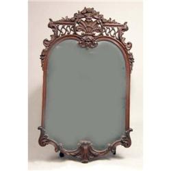 A ROCOCO STYLE CARVED MAHOGANY LOOKING GLASS