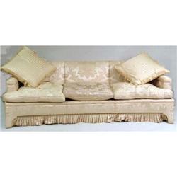 A CONCAVE FRONTED THREE-CUSHION SOFA