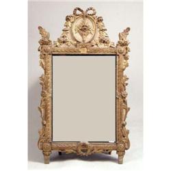 A CARVED GILTWOOD DECORATED NEOCLASSICAL STYLE LOOKING GLASS