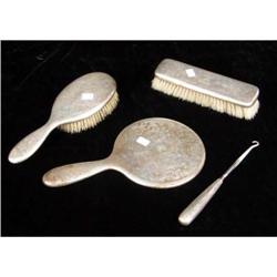 A TIFFANY & CO. MAKERS FOUR PIECE STERLING SILVER HANDLED DRESSER SET