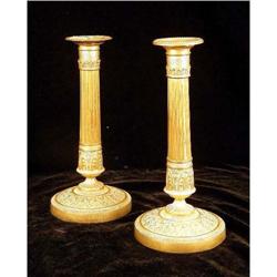 A PAIR OF EMPIRE STYLE BRASS CANDLESTICKS