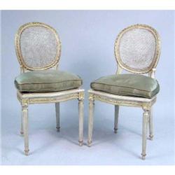 A PAIR OF LOUIS XVI STYLE PAINTED AND PARCEL-GILT CANED SIDE CHAIRS