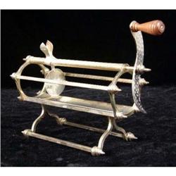 AN ENGLISH SILVER REVOLING CHEESE CUTTER ON STAND