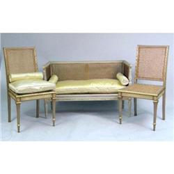 A LOUIS XVI STYLE PAINTED AND PARCEL-GILT SMALL SETTEE