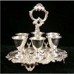 A D & S ROCOCO SILVER ON COPPER HANDLED FOOTED SHAPED OVAL EGG CUP STAND