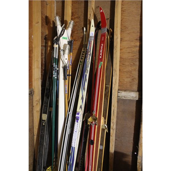 Lot of 4 Pairs of Skis with Rack of Ski Pol 4 Pairs of Poles