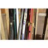 Image 4 : Lot of 4 Pairs of Skis with Rack of Ski Pol 4 Pairs of Poles