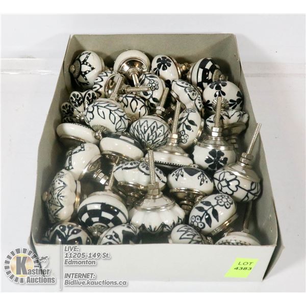 BOX OF ORNATE CABINET DOOR HANDLES.