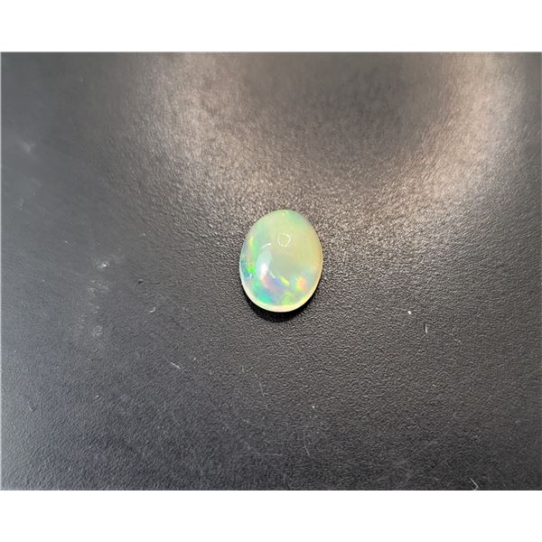 9)  NATURAL OVAL 1.125 CT RAINBOW OPAL