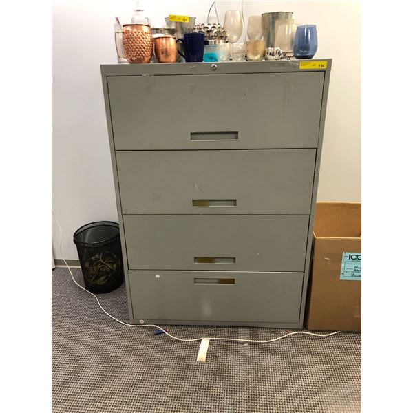 Grey 4 door metal lateral filing cabinet from the production office of the show