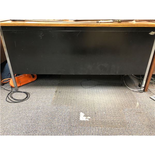Black metal with laminate wood top 4 drawer office desk from production offices of the show