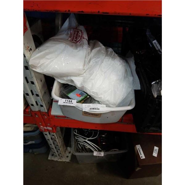 Tote of cable clamps and plastic bags