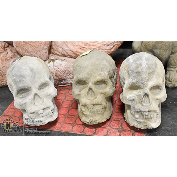 LOT OF 3 CONCRETE SKULL ORNAMENTS, 8" TALL