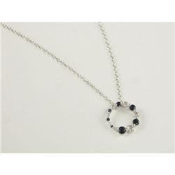 PENDANT WITH CHAIN: Geometric 14k white gold circurlar pendant with chain set with dark blue sapphir