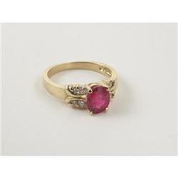 RING: 14k gold lady's ring set with a pink sapphire and 8 diamonds. Sapphire measures approximately 