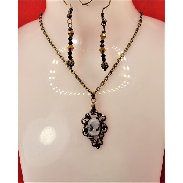 17)  BRONZE TONE WITH PURPLE CAMEO PENDANT