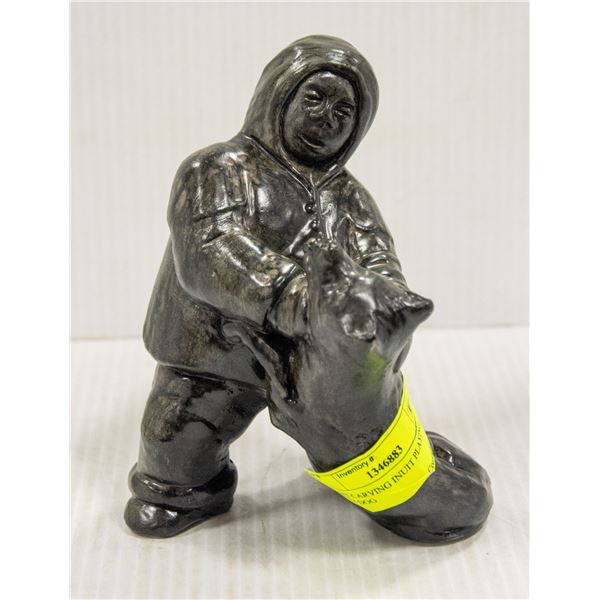 INUIT CARVING INUIT PLAYING WITH DOG