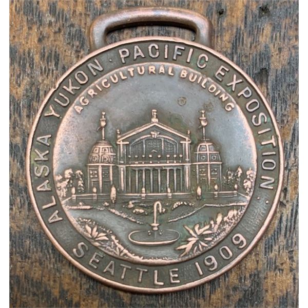 #86 – Official Souvenir – 1909 Watch Fob – ALASKA-YUKON-PACIFIC EXPO – AGRICULTURAL BUILDING