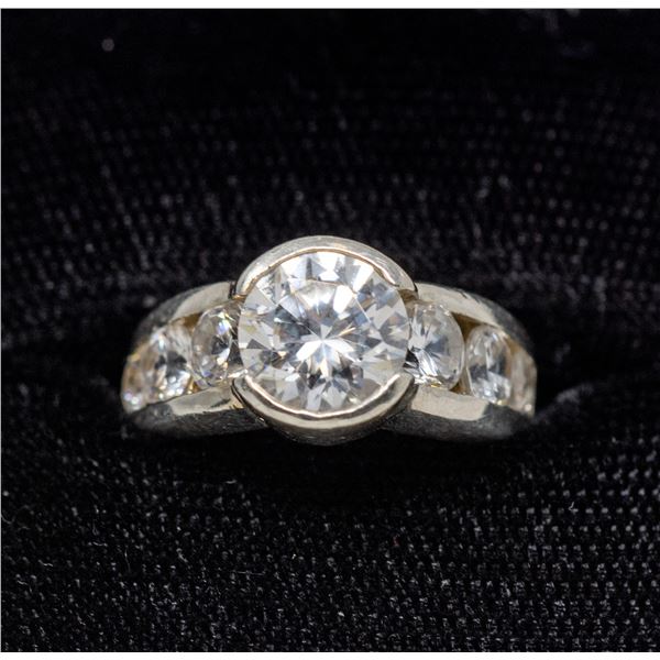 SILVER RING WITH 7 CLEAR STONES, APPROX. SIZE 5