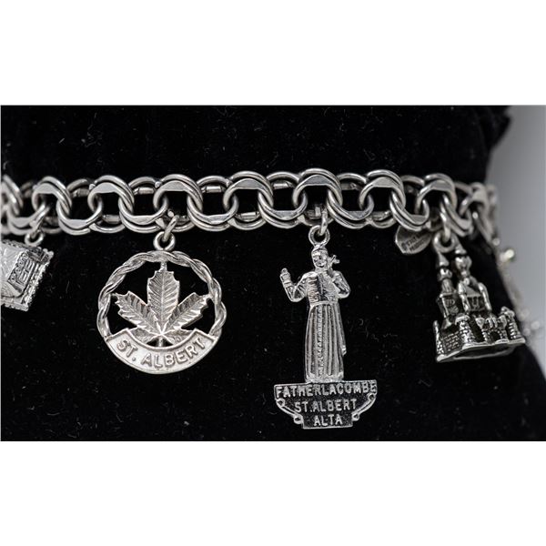 STERLING SILVER CHARM BRACELET WITH 8 CHARMS,