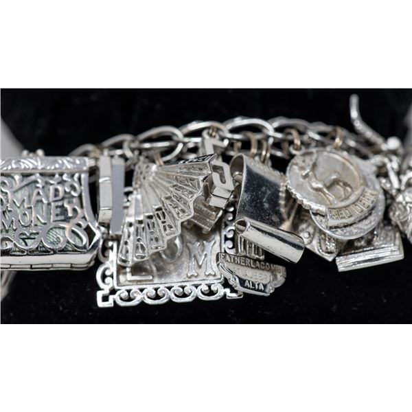 STERLING SILVER CHARM BRACELET WITH 35 CHARMS,
