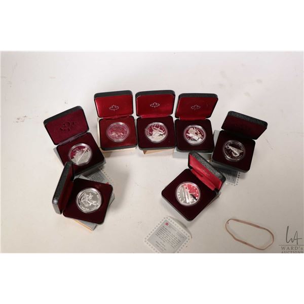 Seven boxed Canadian silver dollars including 1980, 1981, 1982, 1983, 1984, 1986 and 1987