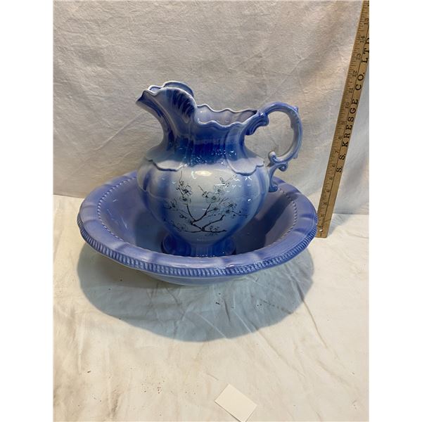 Pitcher and bowl bowl has chip