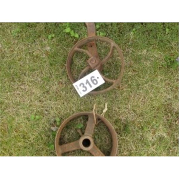 TWO IRON PULLEYS