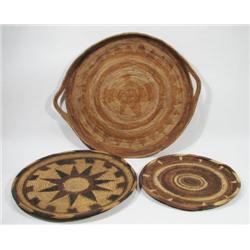 THREE WOVEN CANE BUKA ISLAND TRAYS