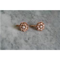 a pair of gold earrings with briljant cut #1936939