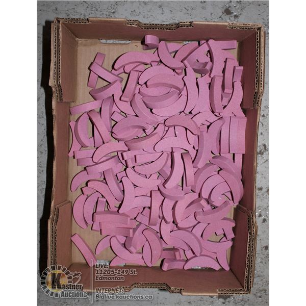 LARGE FLAT OF CURVED GRINDING STONES.