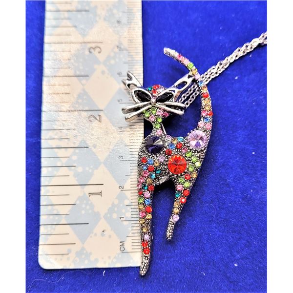 9)  SILVER TONE AND MULTI COLORED CRYSTAL